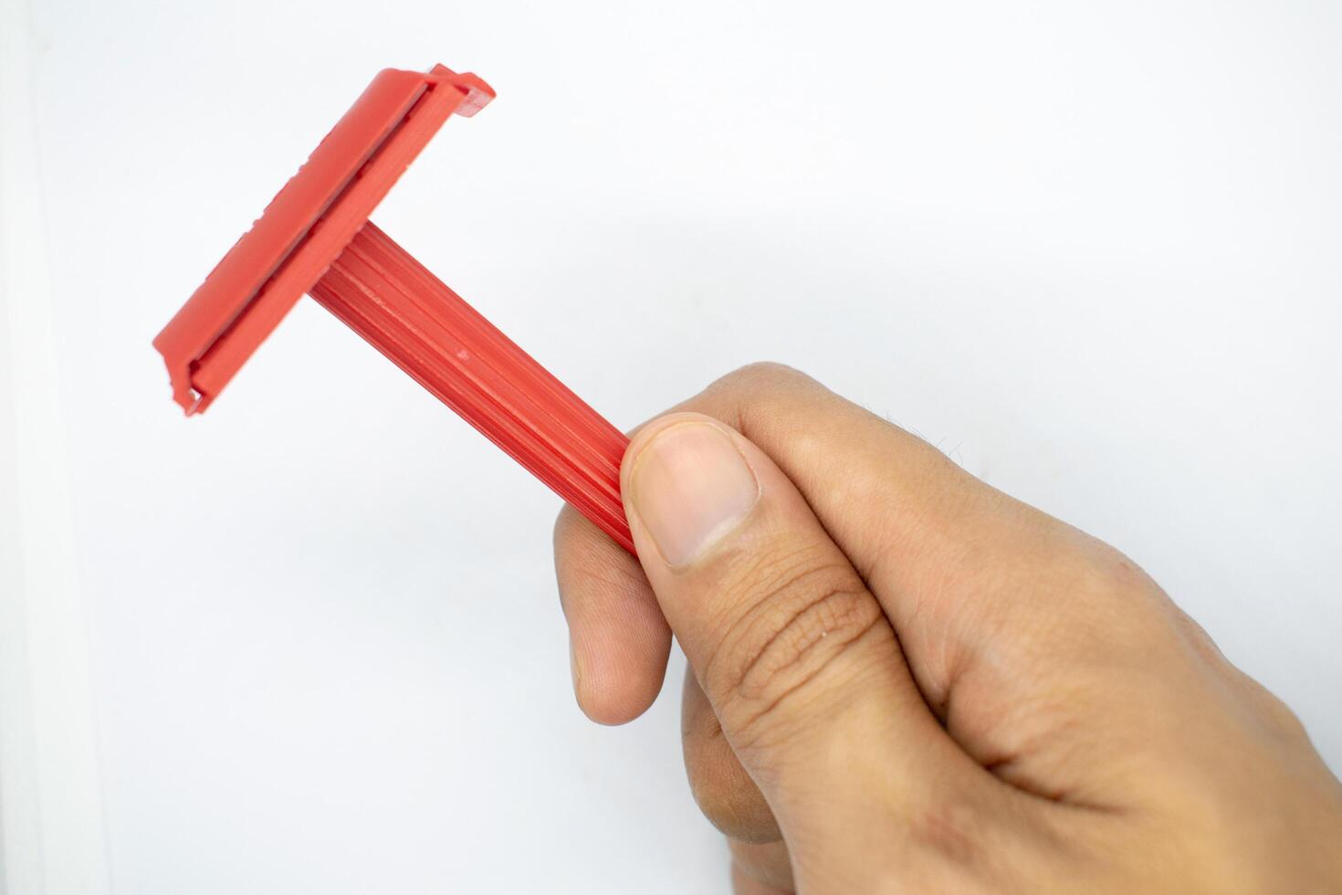 hand holding a razor on a white background photo