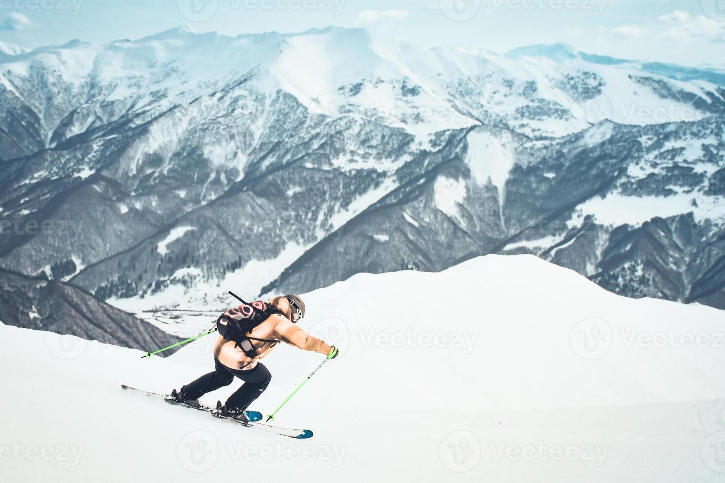 Close up dynamic sports banner of man skier on piste ski downhill fast motion in Alps. Active winter holidays, skiing downhill in overcast day. Ski rides on the track with swirls of fresh snow photo