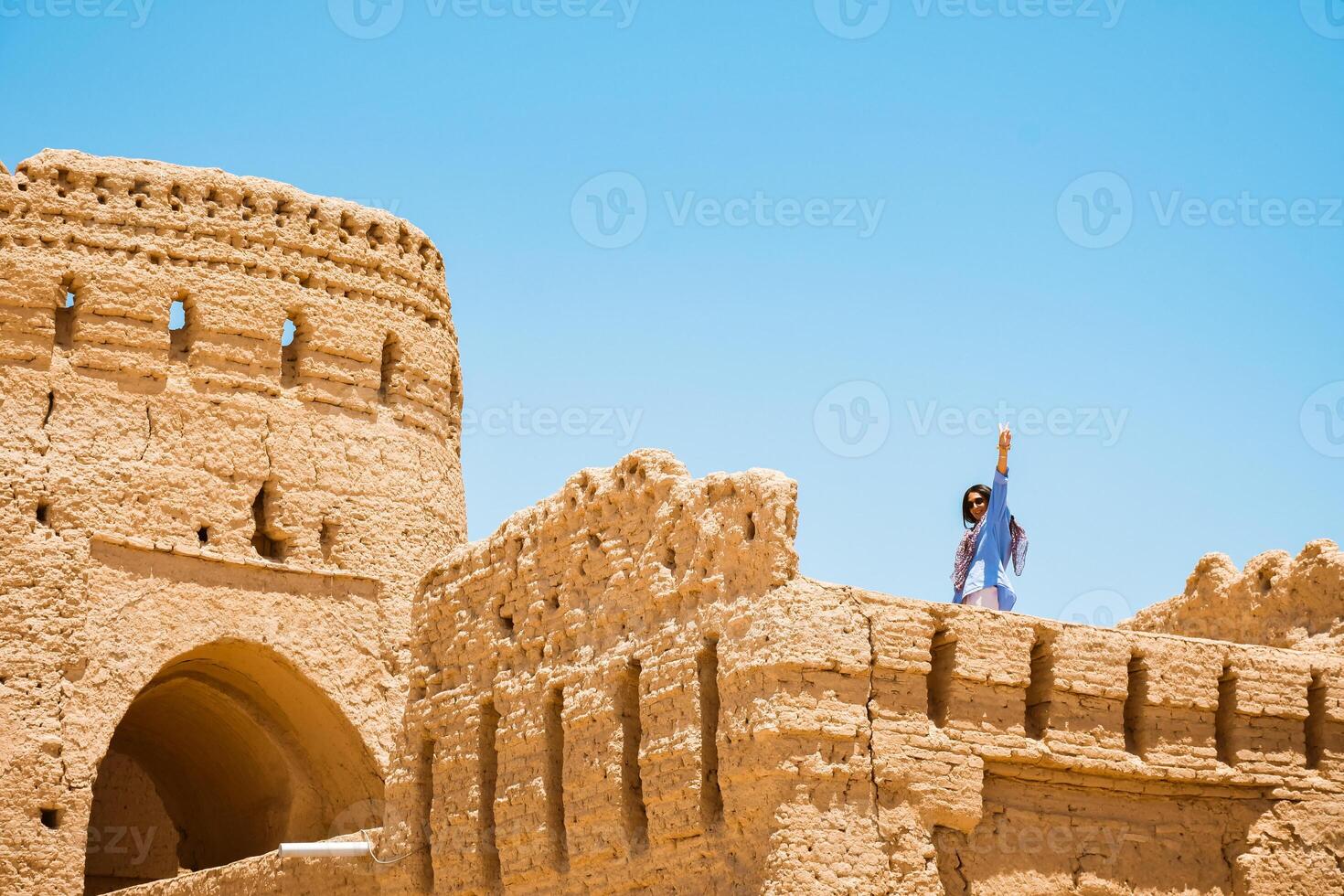 Tourist woman walk in ancient Narin Qal'eh Qaleh clay castle in the centre of Meybod near Yazd in Iran is one of the best preserved mud-brick fortresses photo