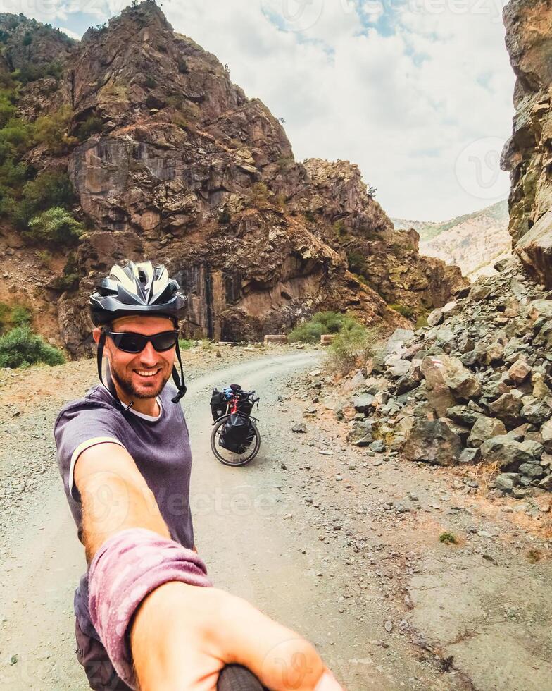 Inspirational smartphone self-portrait portrait excited joyful caucasian male cyclist standing by touring bicycle looking to camera smiley face. Stand confident enjoy carefree lifestyle photo