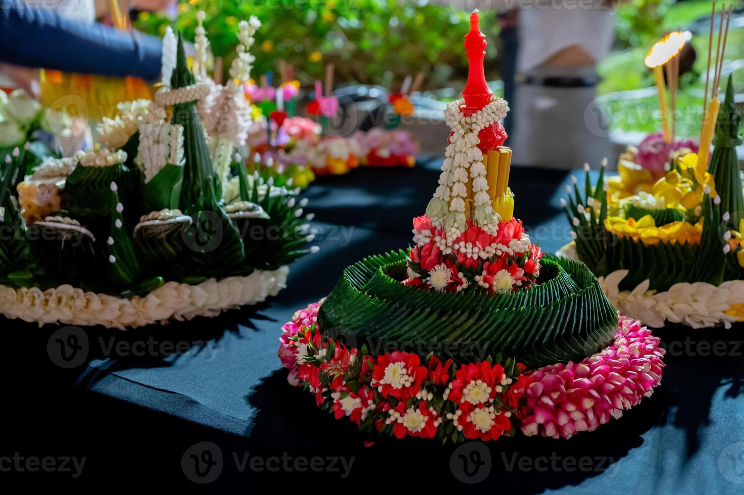 White garland puts on top with red candle to decorate beautiful Krathong that made from banana leaves and flowers for Loy Krathong festival in Thailand. photo
