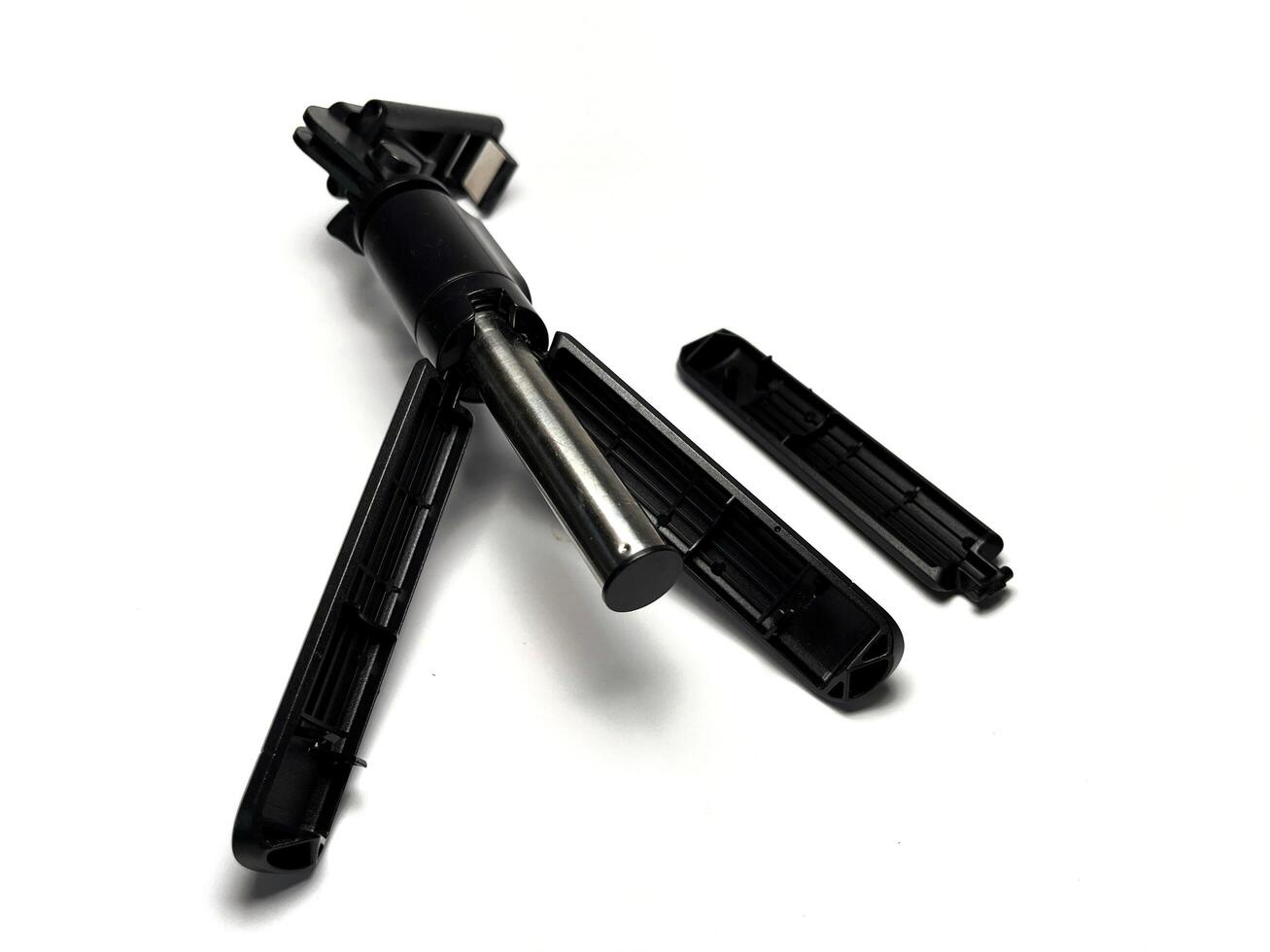 Broken mobile phone tripod isolated on white background with clipping path. Studio shot. photo