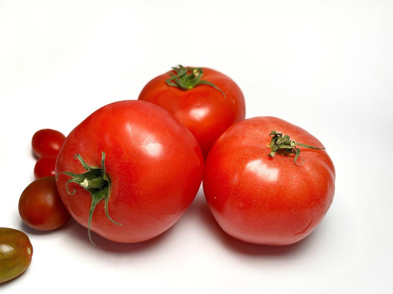 Close up of fresh tomato and cherry tomato. Healthy vegetables. Food ingredient. photo