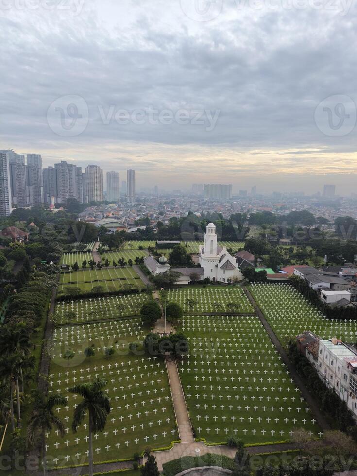 The cemetery is surrounded by apartments and hotels in the city of Jakarta photo