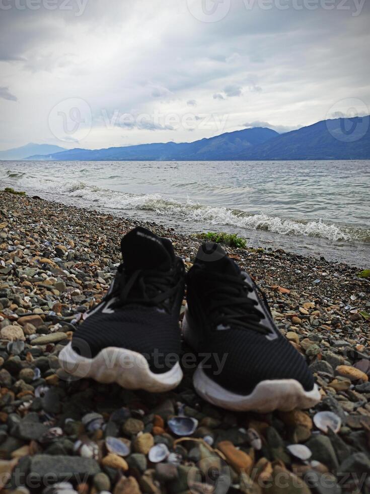 A pair of shoes on the shore of Lake Singkarak, West Sumatra photo