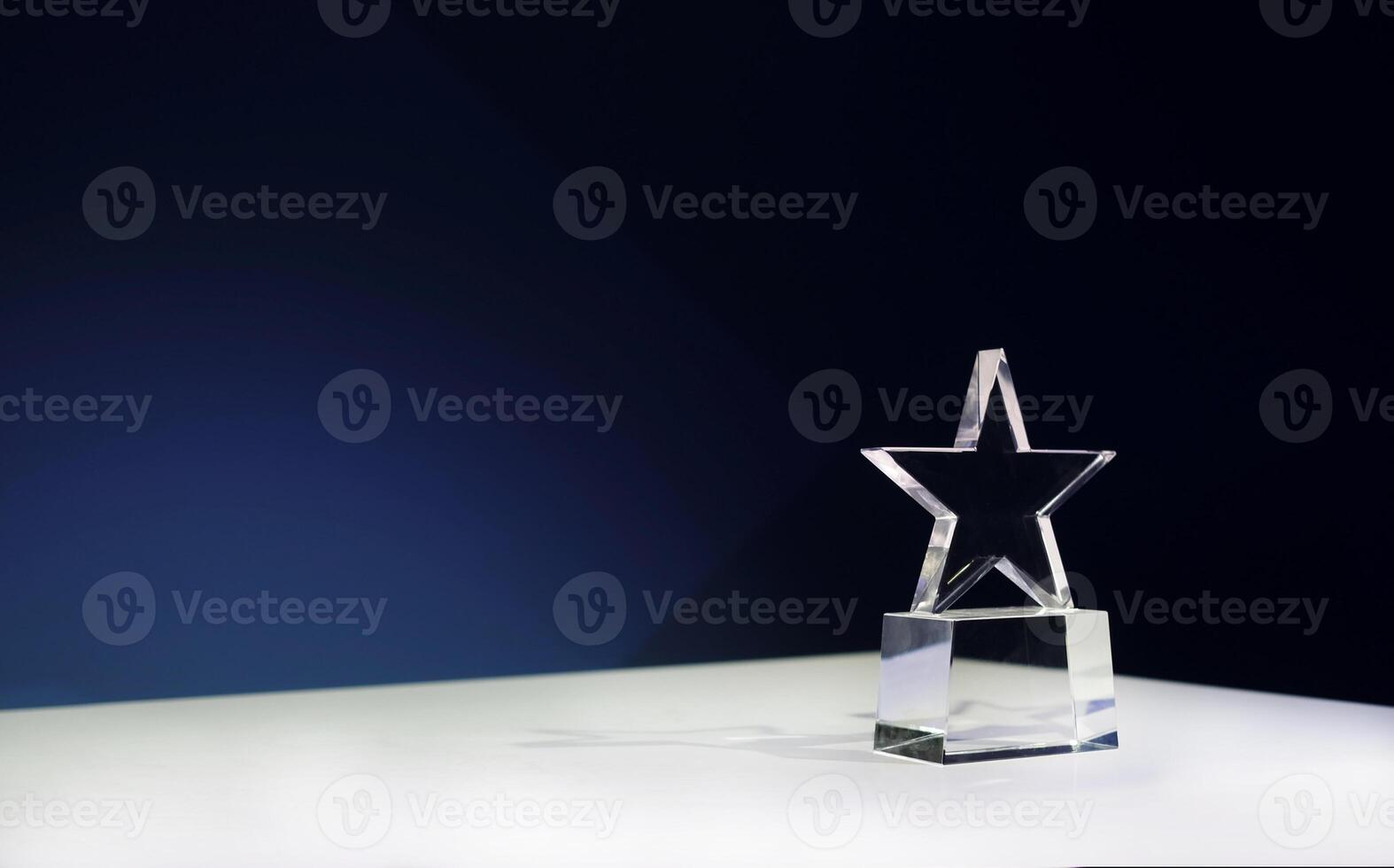 Star-shaped award on a table with spotlights and copy space photo