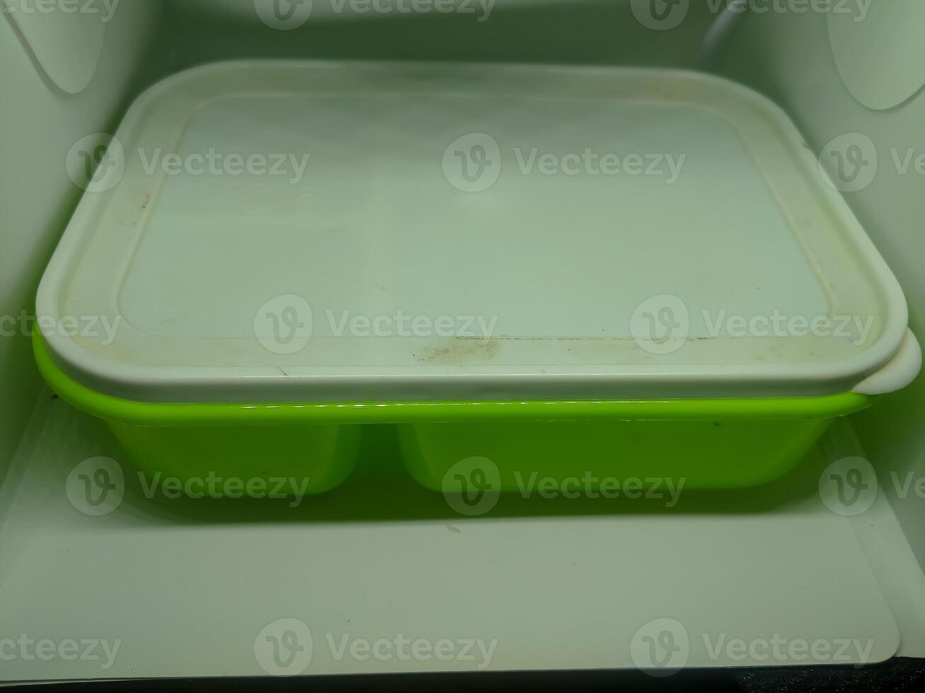 A green plastic container with a lid photo