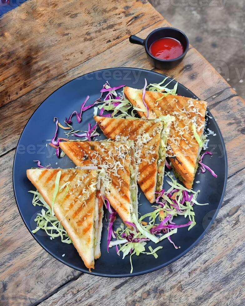 a plate with grilled sandwiches and ketchup on the side photo