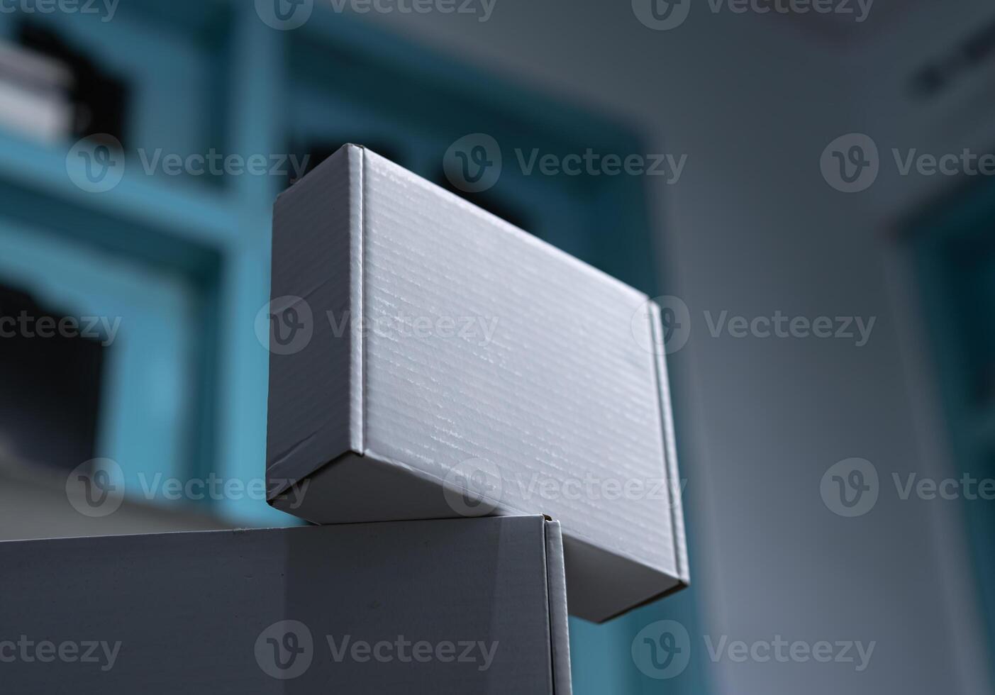 A white box sitting on top of another white box in a room photo