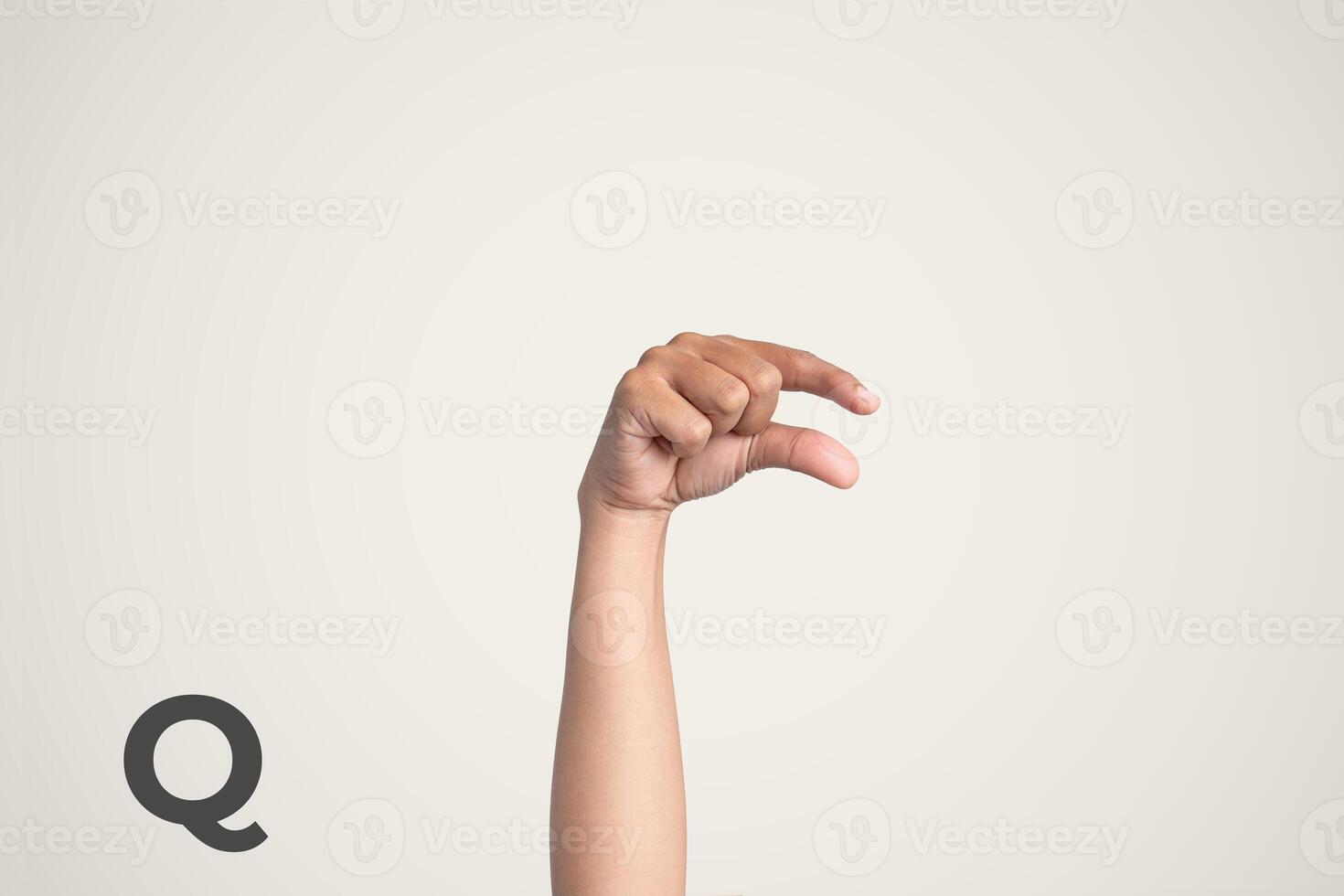 Deaf Sign alphabet of Q, American Sign Language ASL. Isolated object Finger spelling the alphabet photo