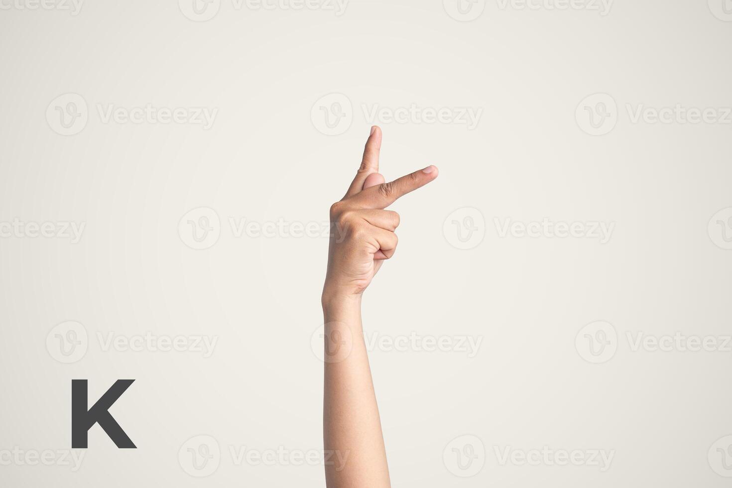 Deaf Sign alphabet of K, American Sign Language ASL. Isolated object Finger spelling the alphabet photo