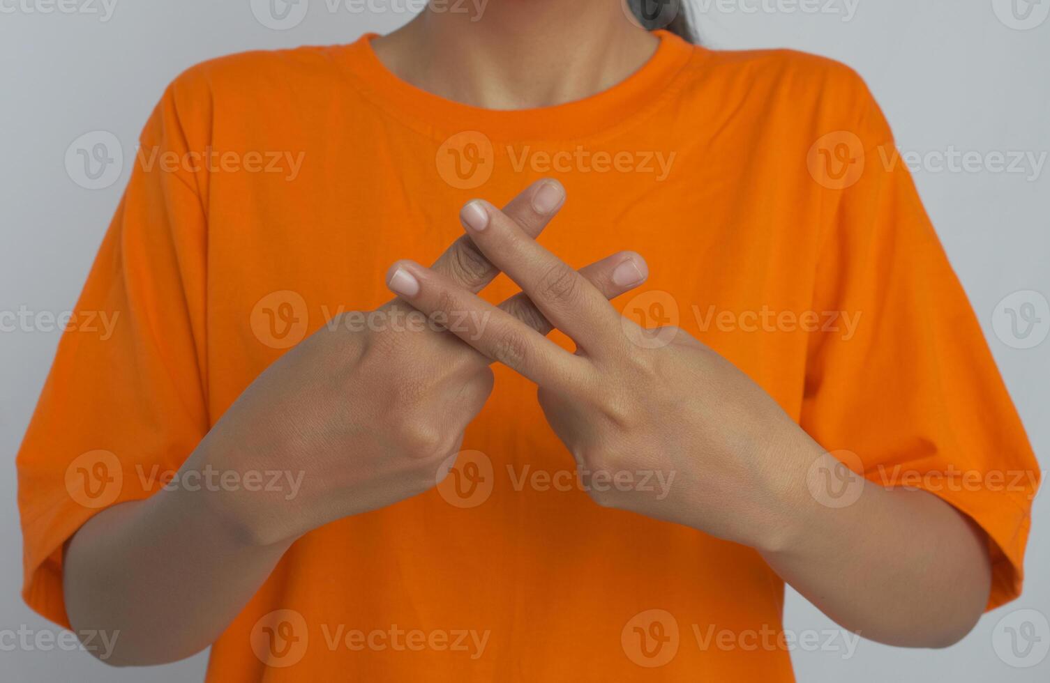 A person with their fingers crossed. Sign language photo