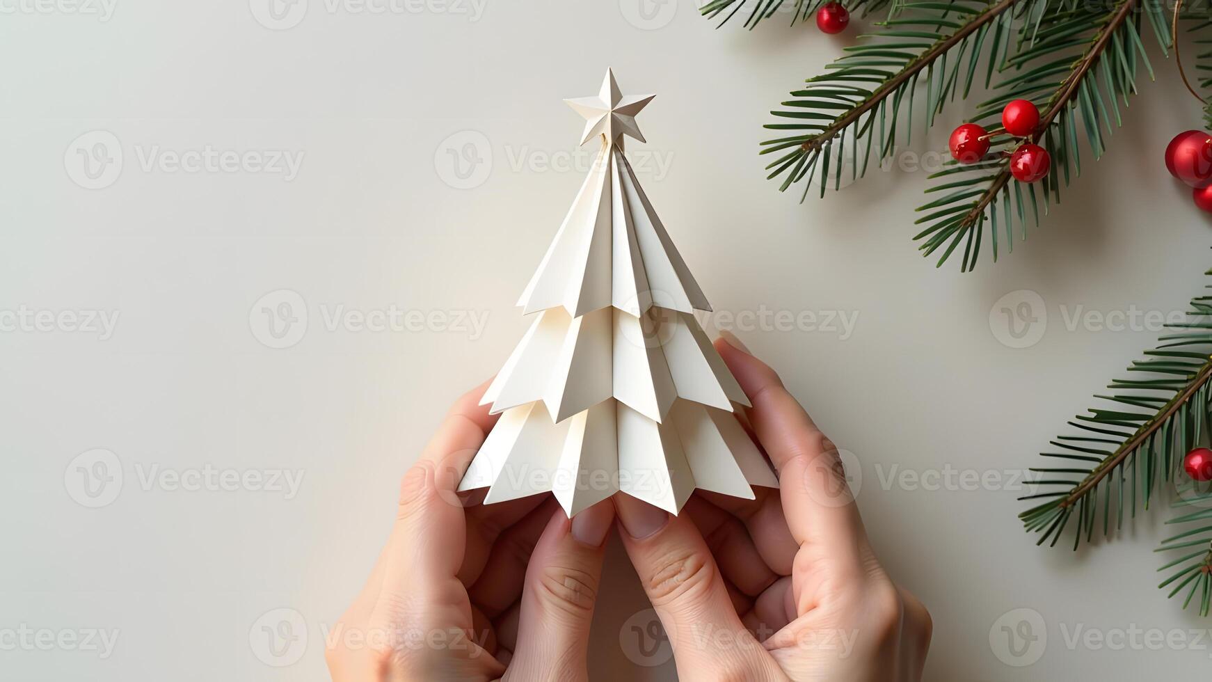 Holding a handmade paper Christmas tree in neutral holiday setting photo