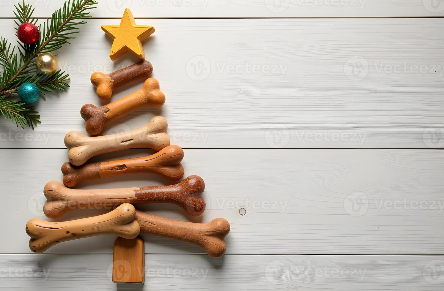 Christmas tree made of dog bones with ornaments and a star on a wooden background photo