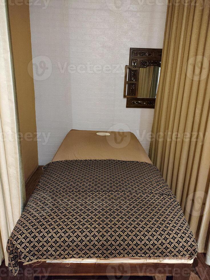 Cozy and Tranquil Massage Room with Soft Lighting and Comfortable Bed photo