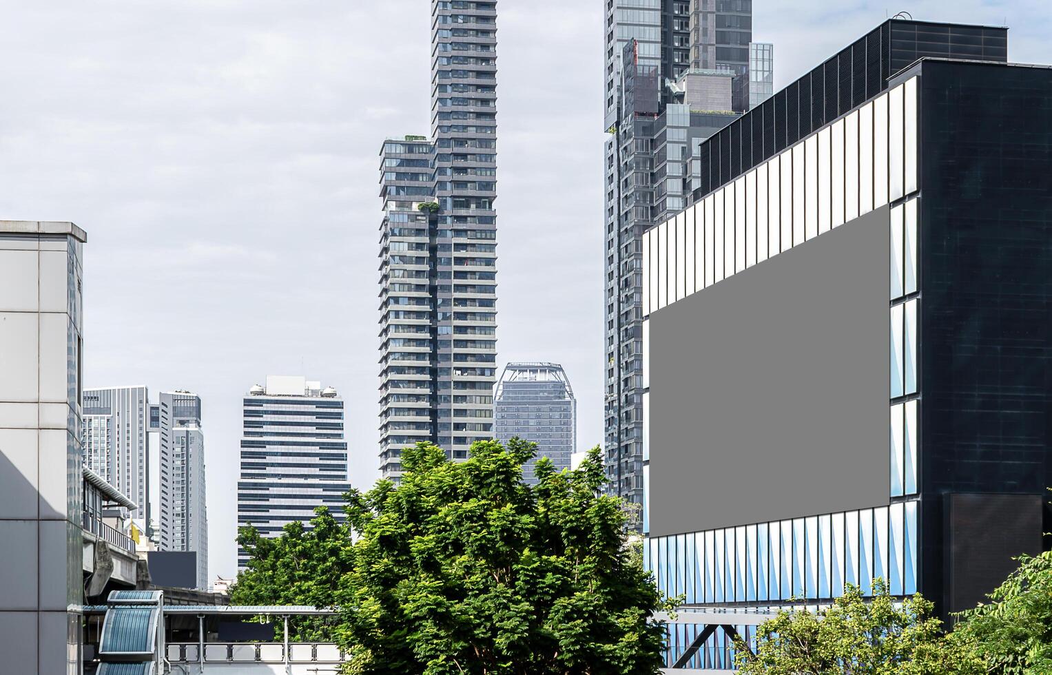 Mock up gray LED display billboard on modern building with cityscape background .Clipping path for mockup photo