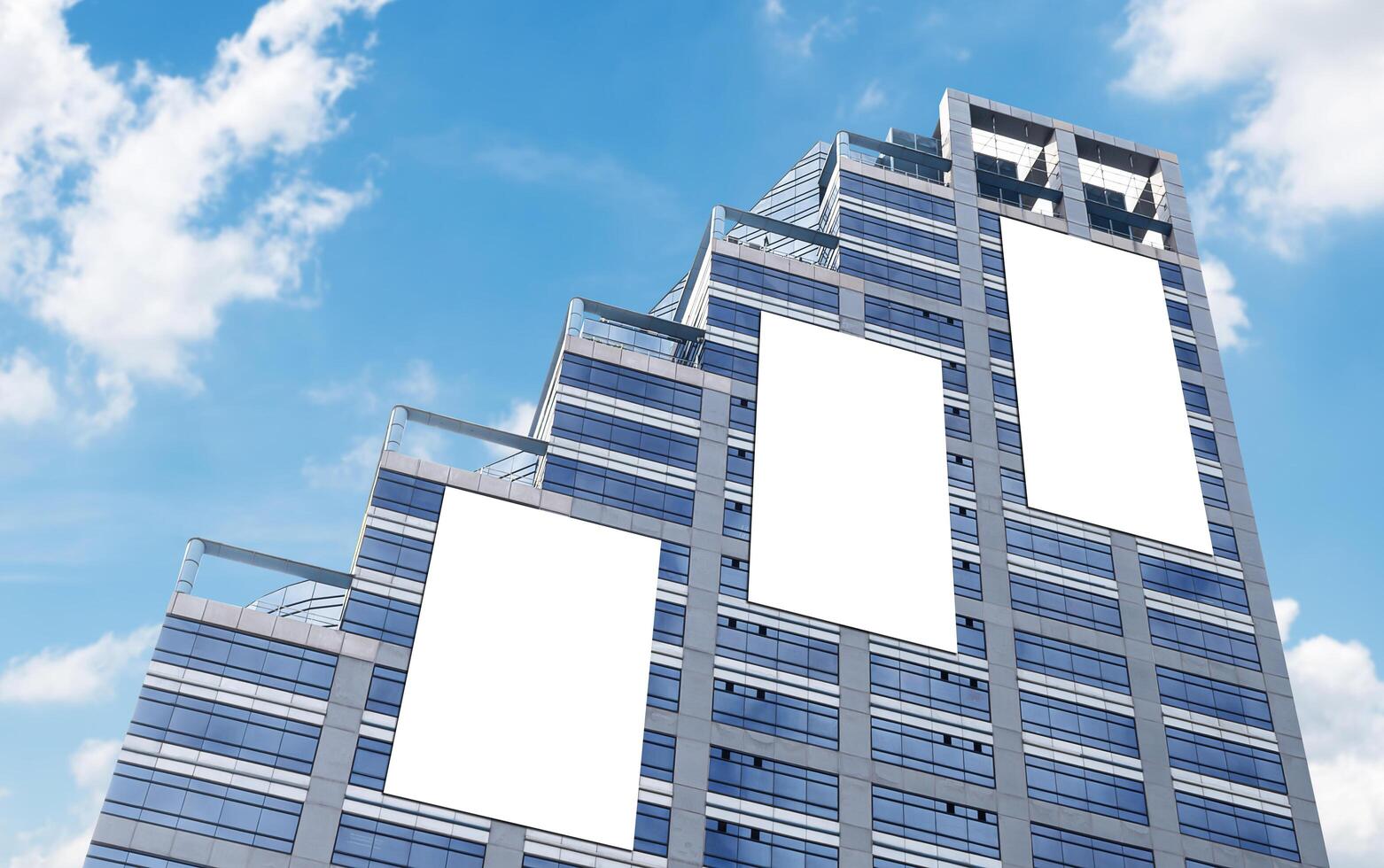 Mock up three white vertical large LED display billboard on tower building with blue sky background .clipping path for mockup photo