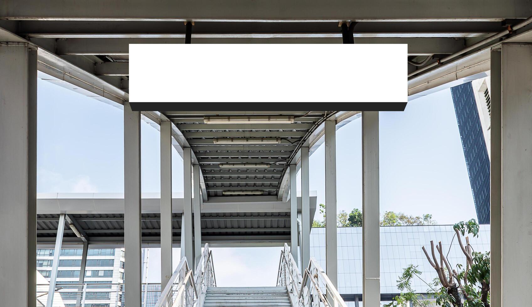 Mock up hanging white rectangle billboard at footbridge photo