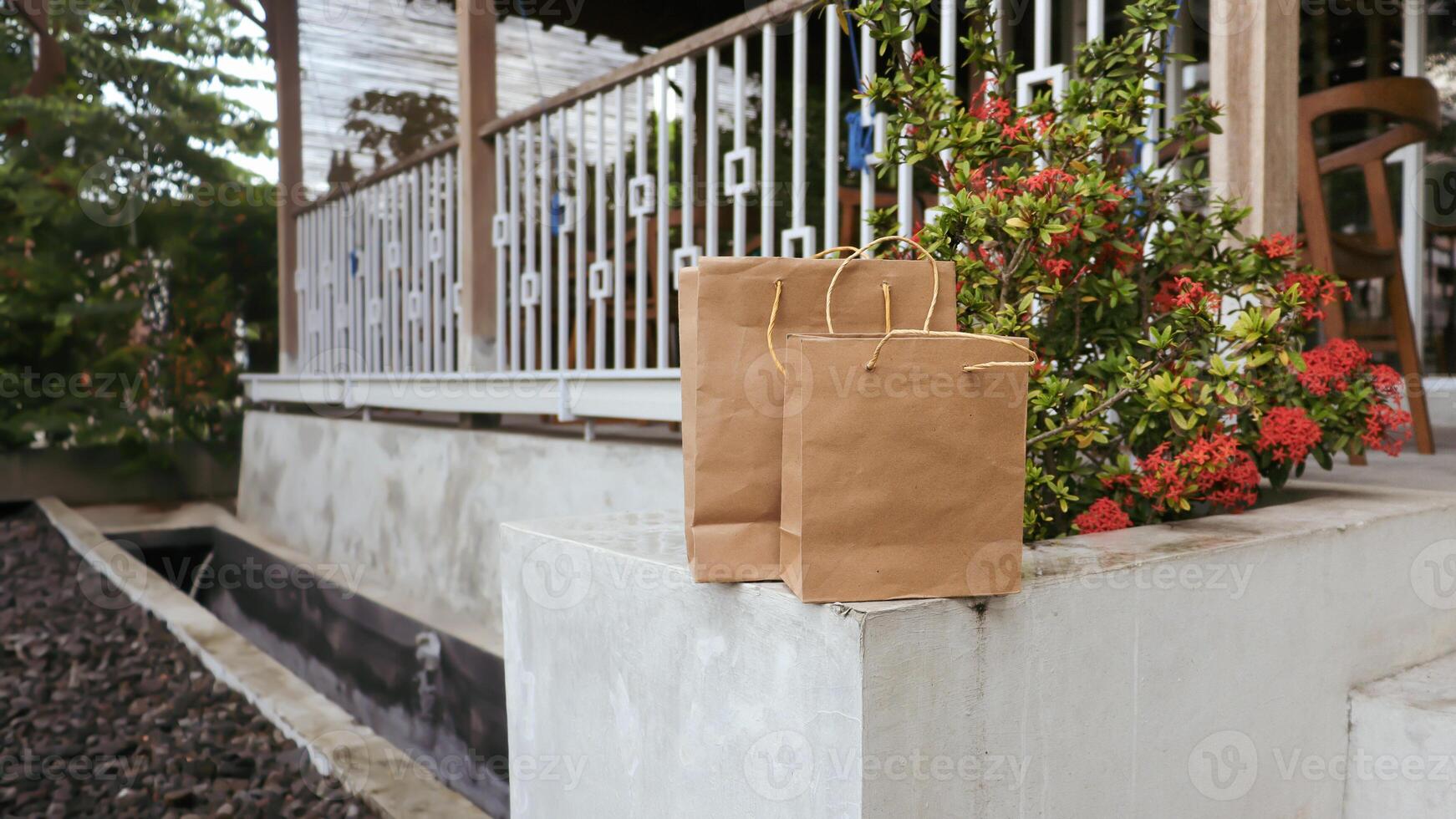 Package of paper bags lying in front of the house photo