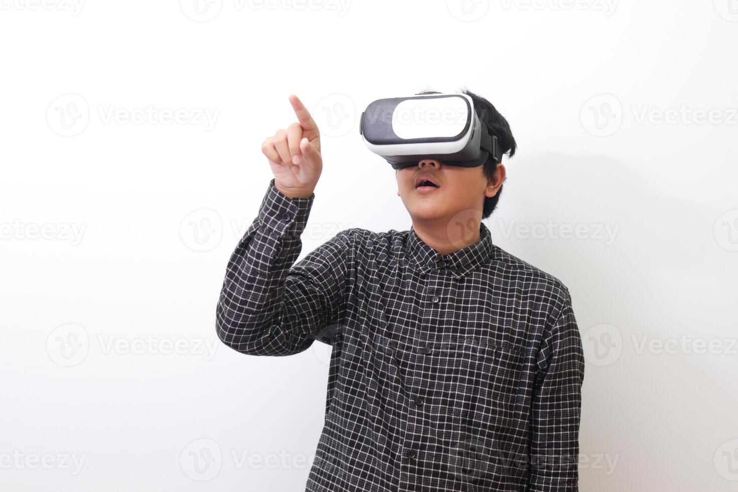 Portrait of Asian man in black plaid shirt using Virtual Reality VR glasses and trying to touch something in front of him. Isolated image on white background photo