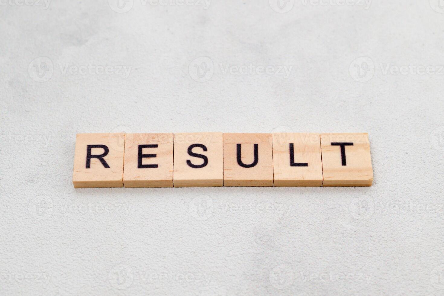 Top view of Result word on wooden cube letter block on white background. Business concept photo