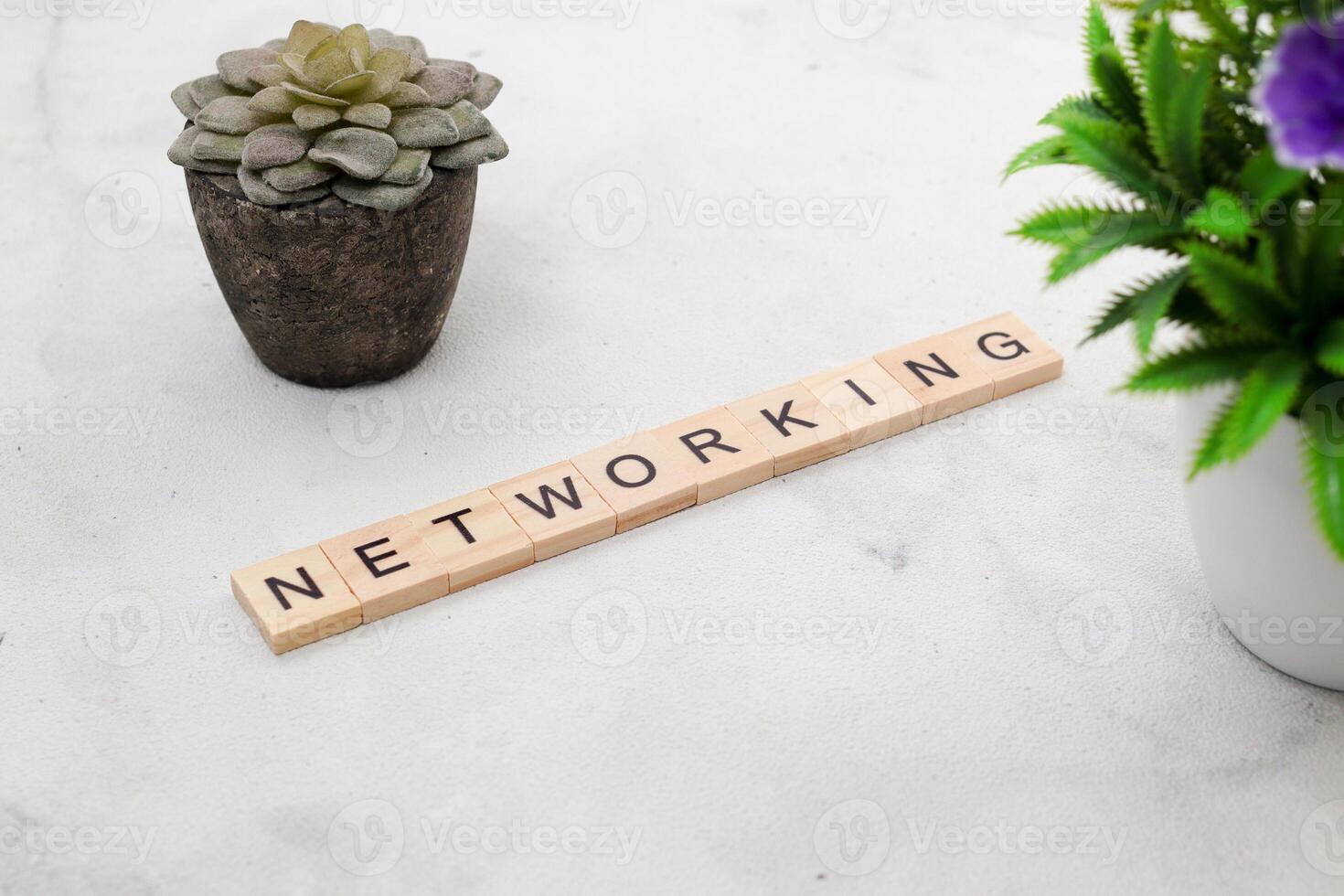 Top view Networking word on wooden cube letter block on white background. Business concept photo
