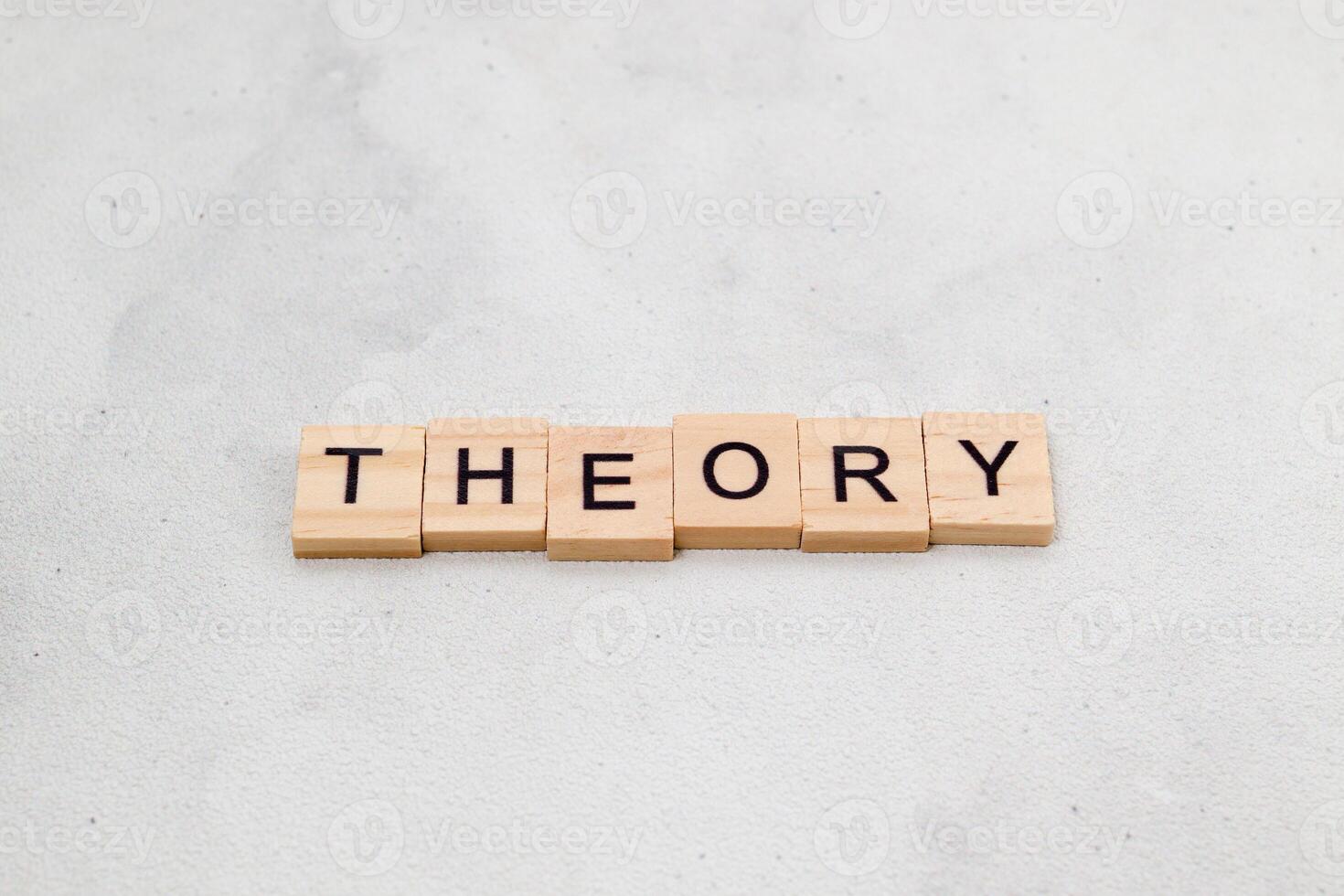 Top view of Theory word on wooden cube letter block on white background. Business concept photo