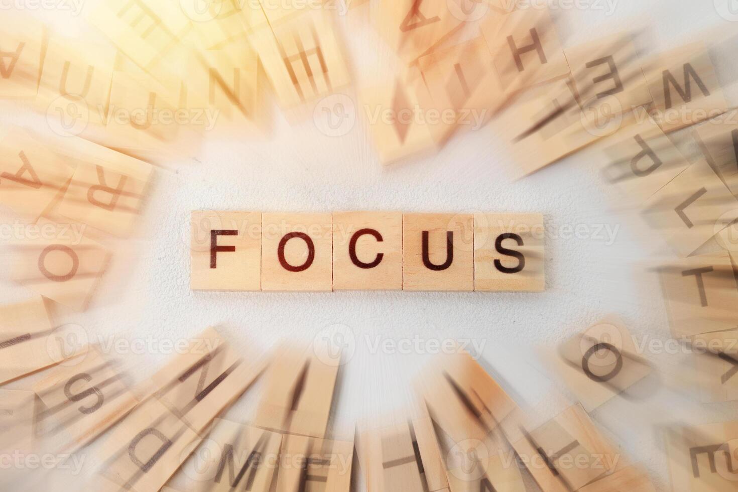 Top view of Focus word on wooden cube letter block on white background. Business concept photo