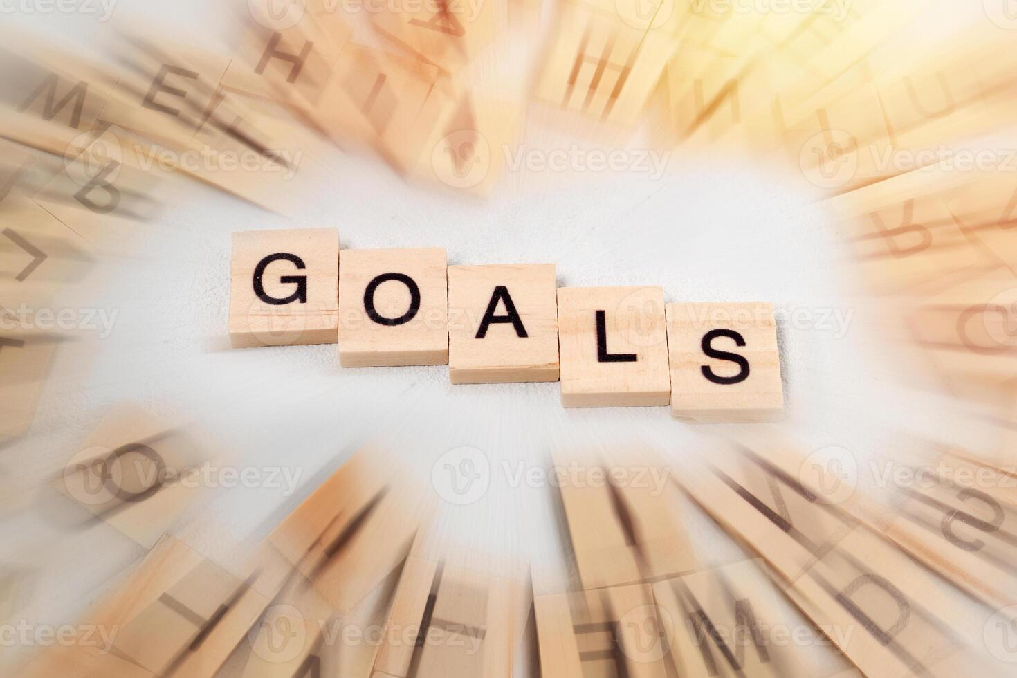Top view of Goals word on wooden cube letter block on white background. Business concept photo