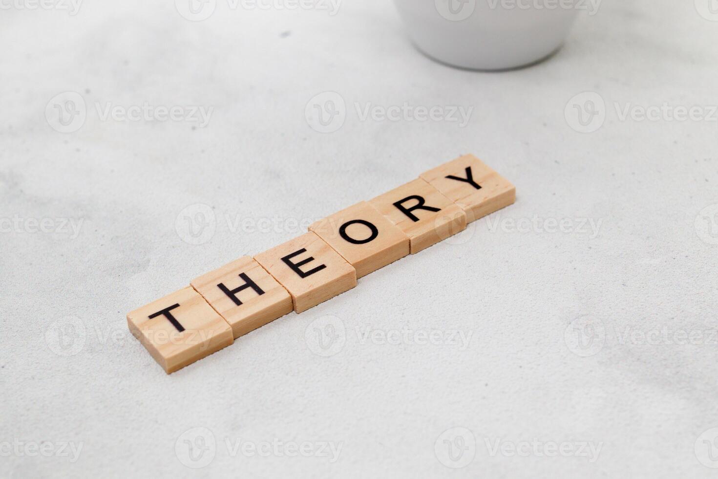Top view of Theory word on wooden cube letter block on white background. Business concept photo