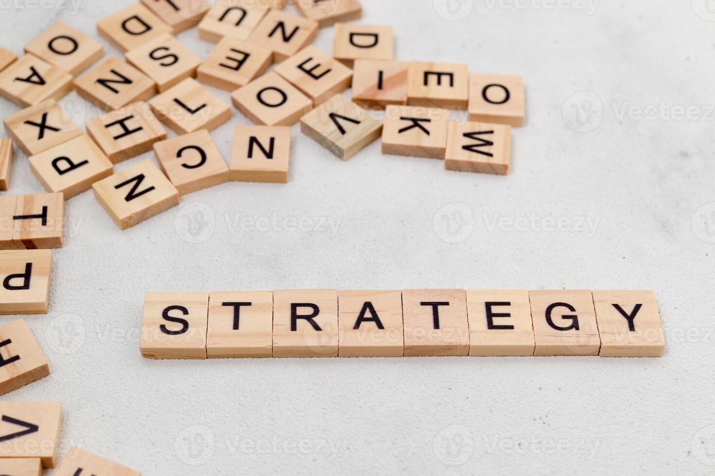 Top view of Strategy word on wooden cube letter block on white background. Business concept photo
