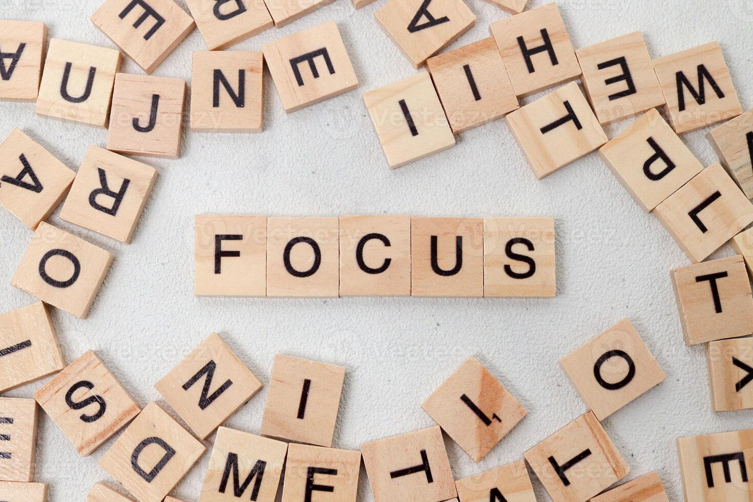 Top view of Focus word on wooden cube letter block on white background. Business concept photo