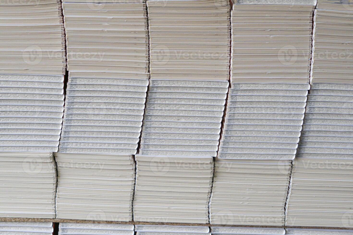Stacks of books after going through printing production in the offset industry. Pile of books ready to enter the finishing stage of lamination photo
