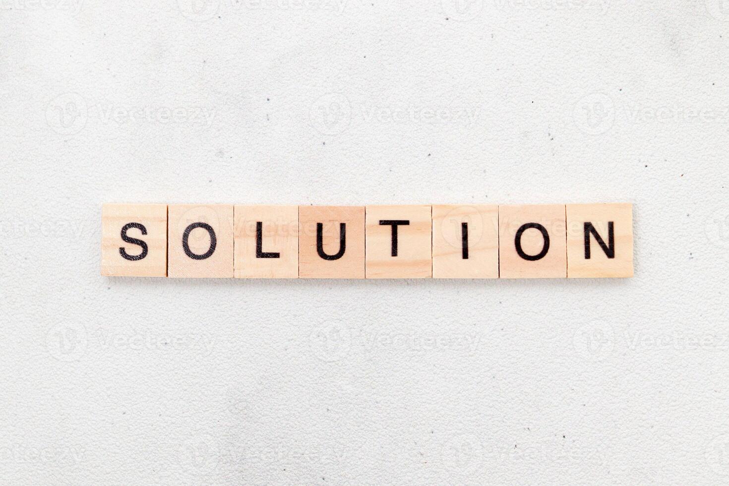 Top view of Solution word on wooden cube letter block on white background. Business concept photo