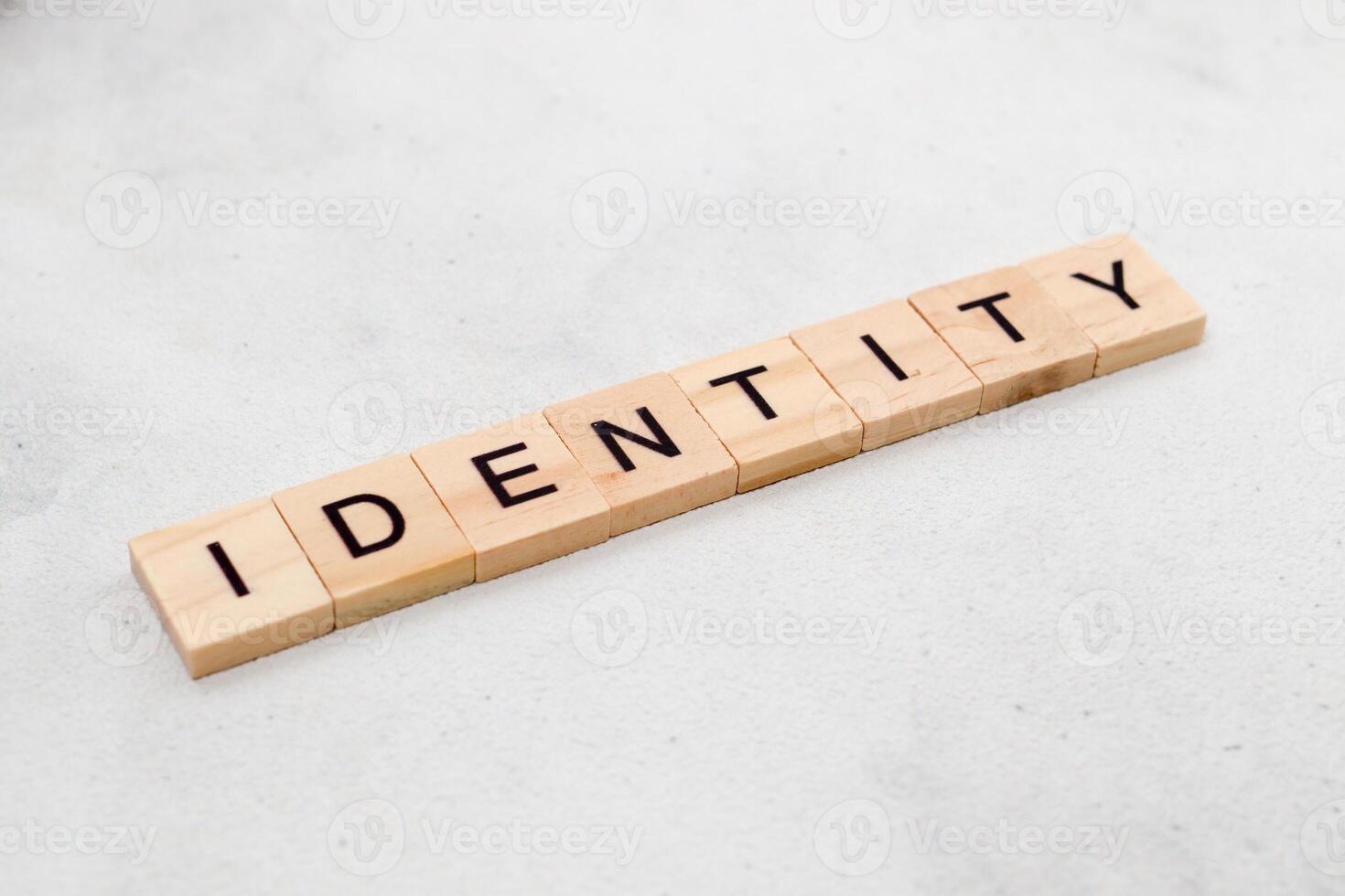 Top view of Identity word on wooden cube letter block on white background. Business concept photo
