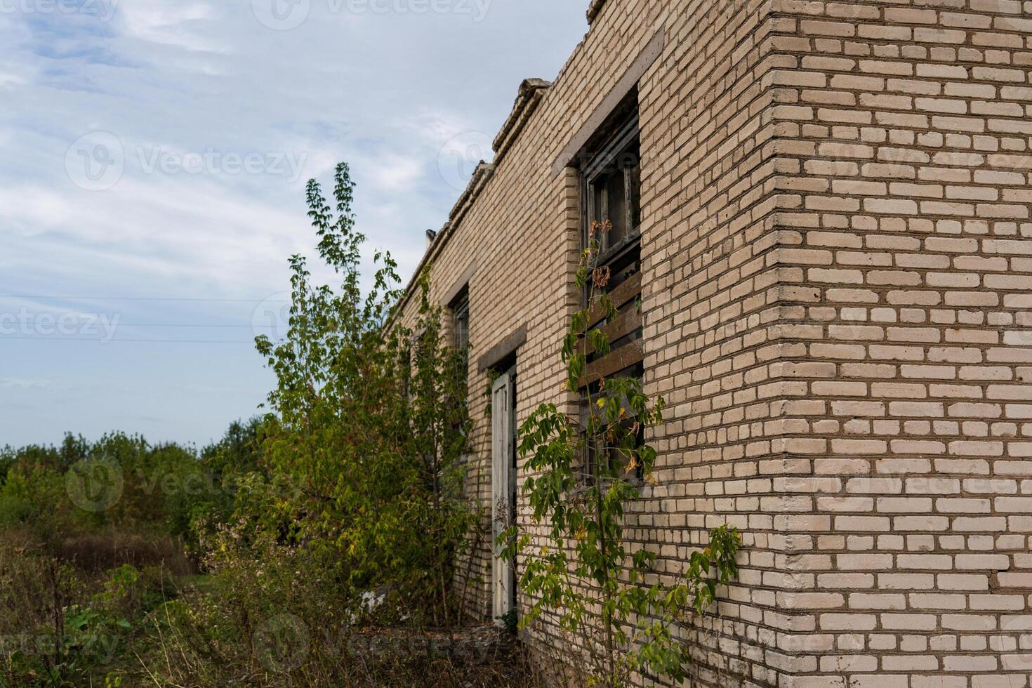 Corner of an old, abandoned, brick store building in the village photo