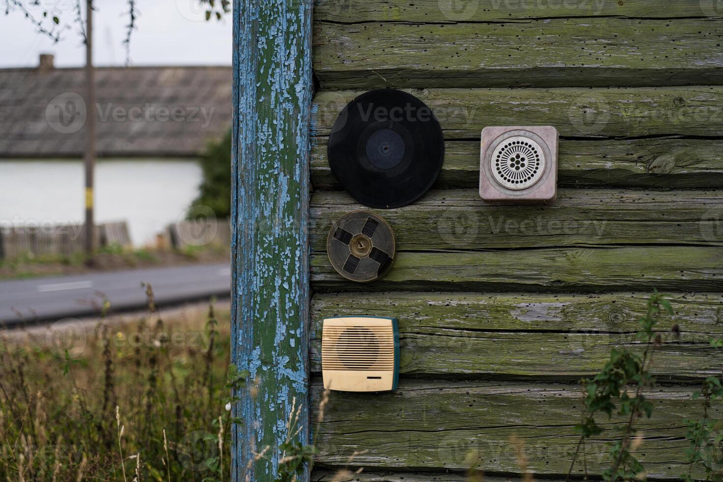 All sorts of junk hangs on the wall of a wooden, rustic house photo