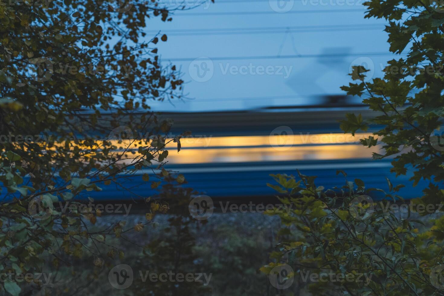 The electric train goes fast in the evening. Long exposure, lubrication photo