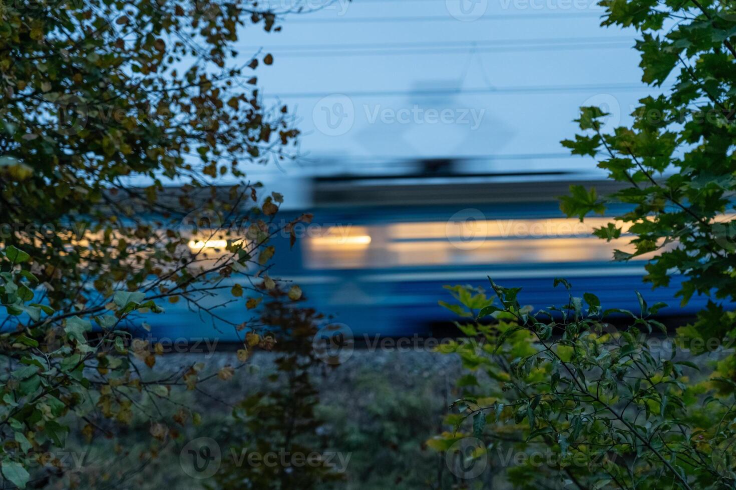 The electric train goes fast in the evening. Long exposure, lubrication photo
