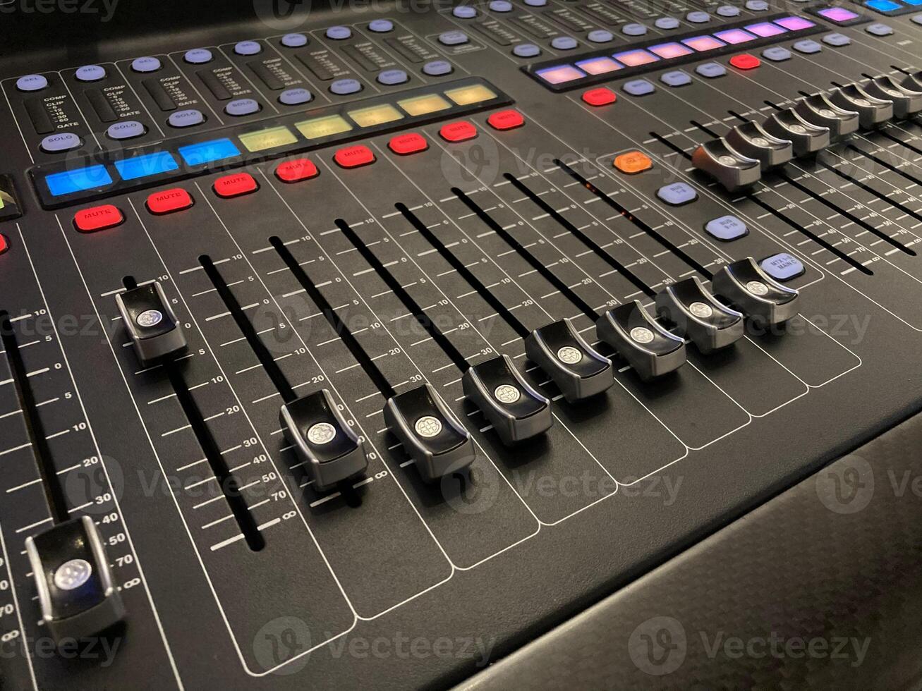 a close up of a mixing board with multiple knobs photo