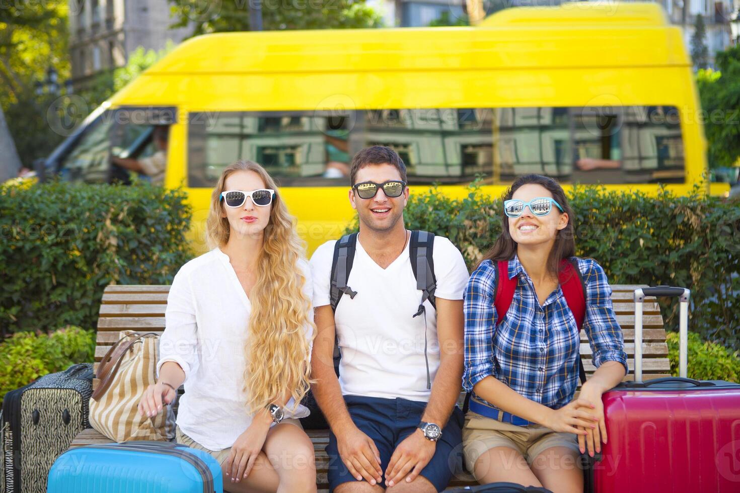 Travelers friends with luggage in the city photo