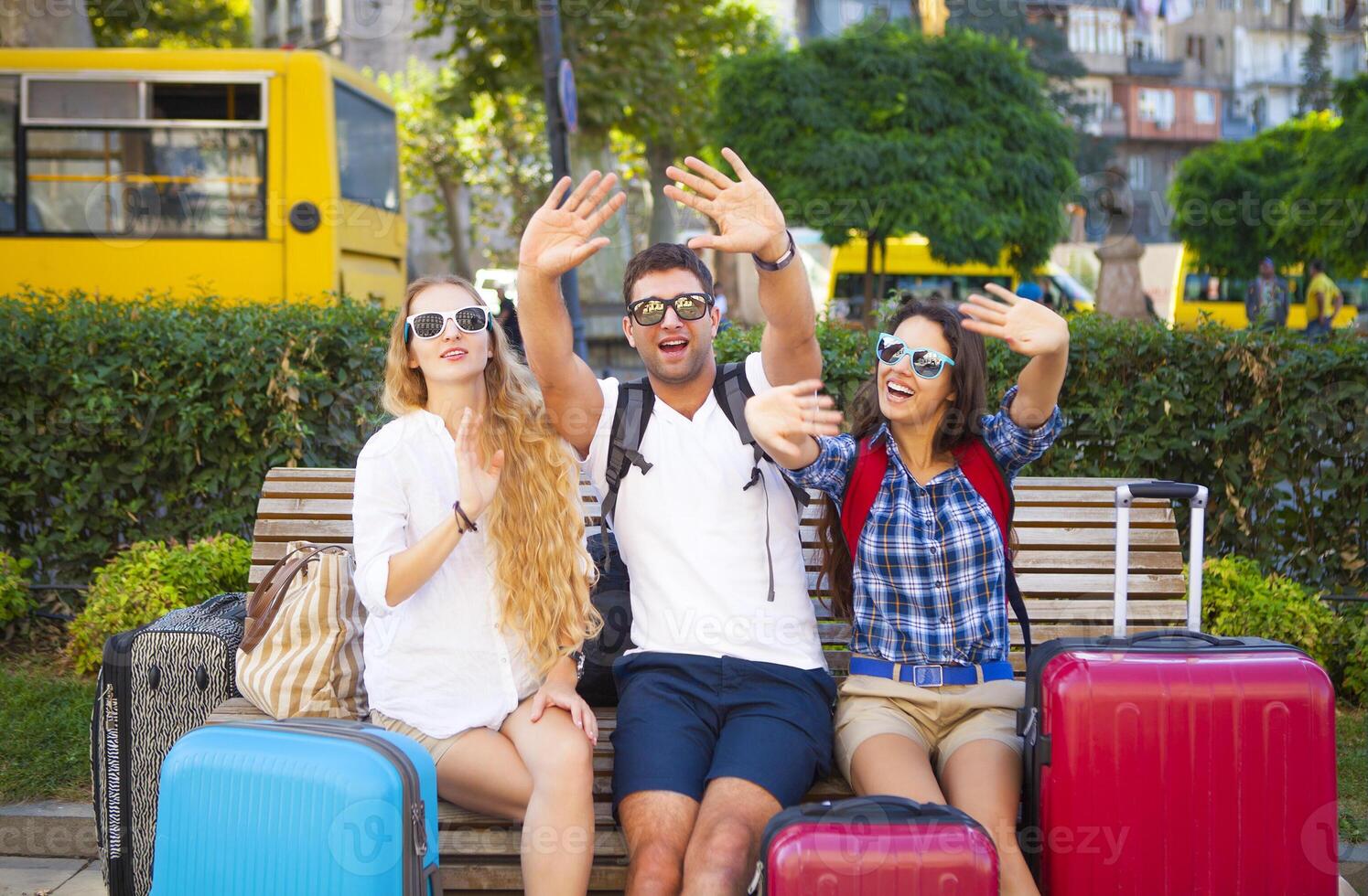 Travelers friends with luggage in the city photo