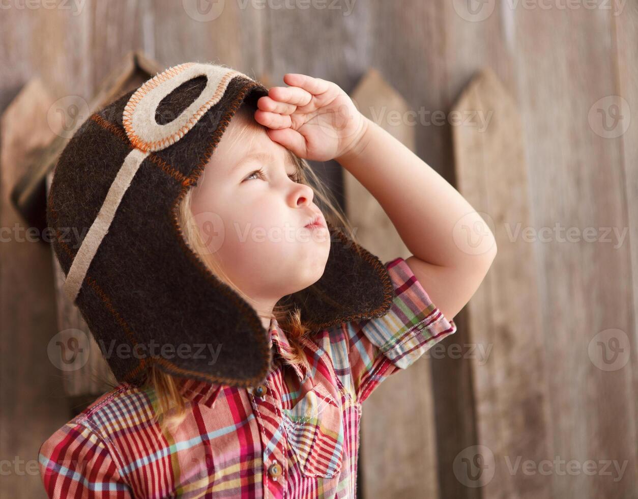 Happy kid playingin pilot helmet photo