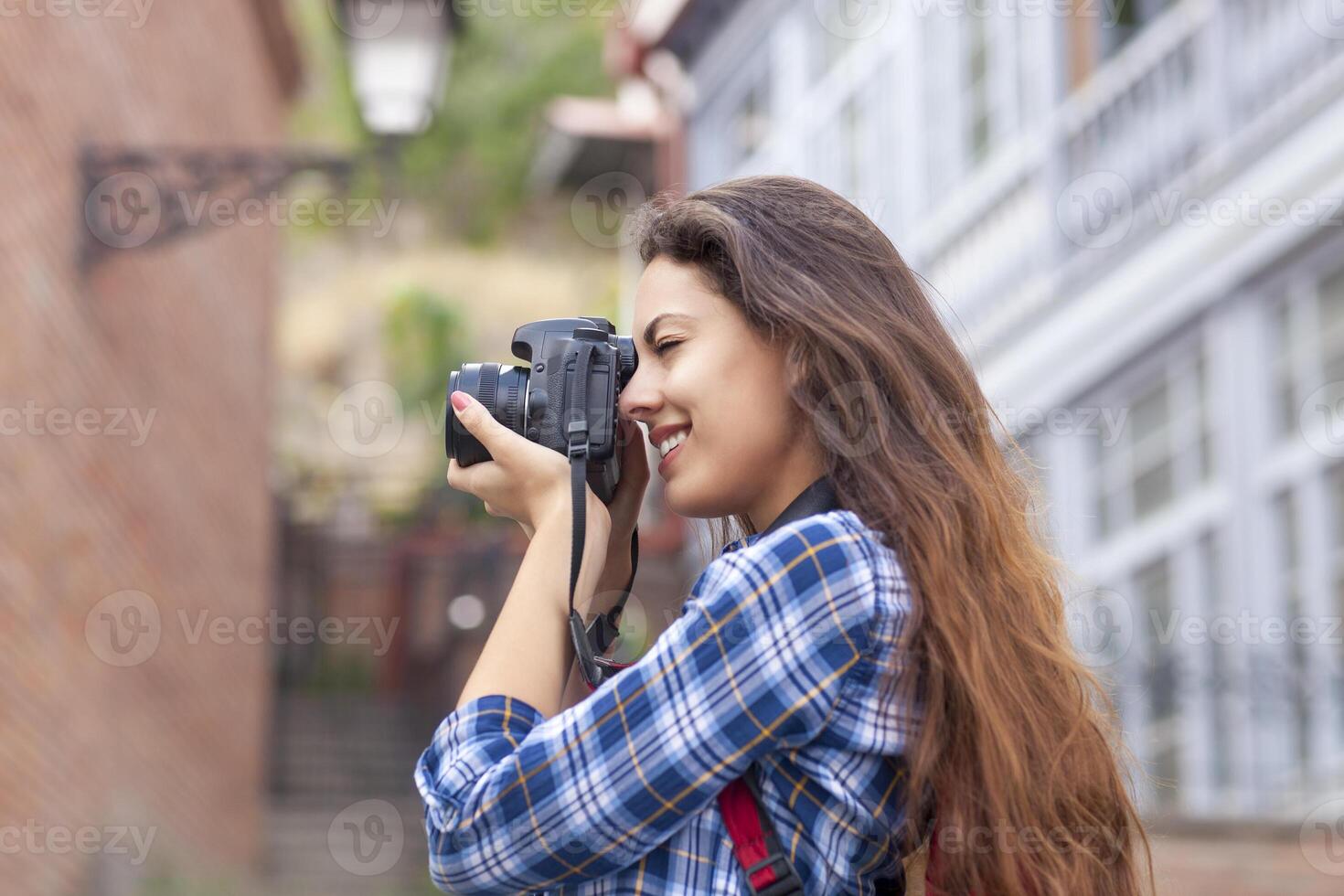 Outdoor summer smiling lifestyle portrait of pretty young woman having fun in the city in Europe photo