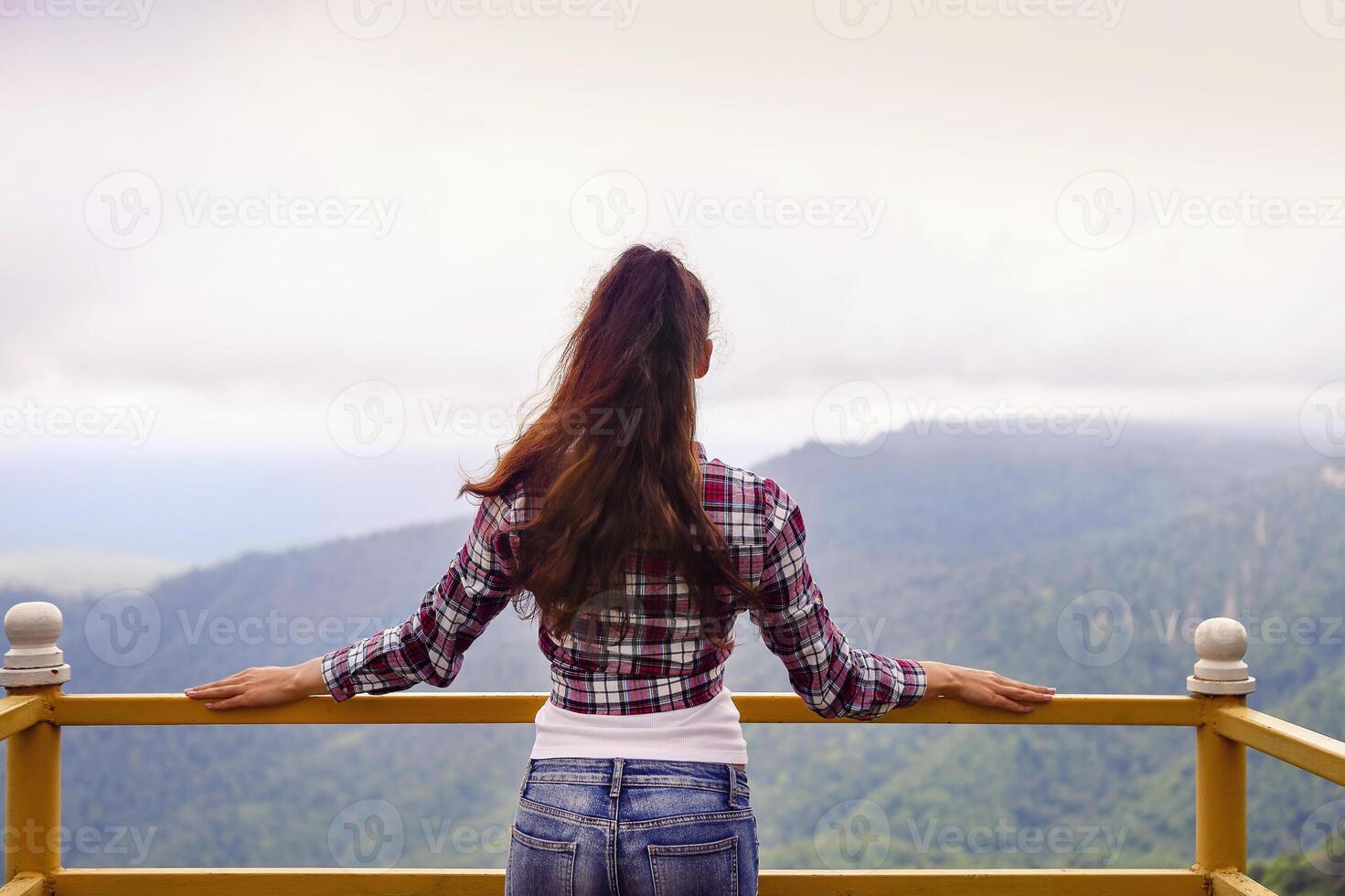 Beautiful brunette woman in mountains photo