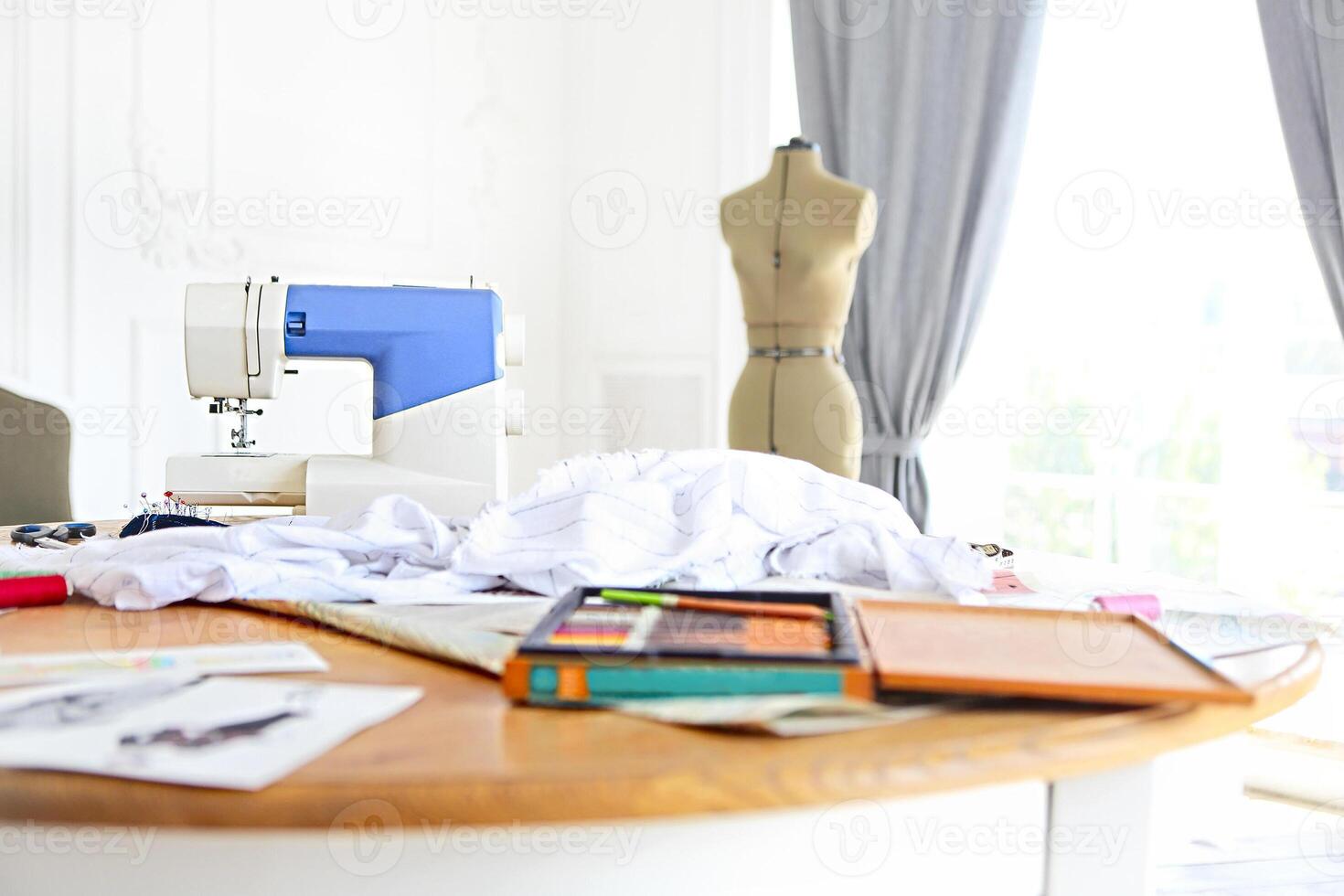 Dummy and other sewing equipment in the desighners workplace photo