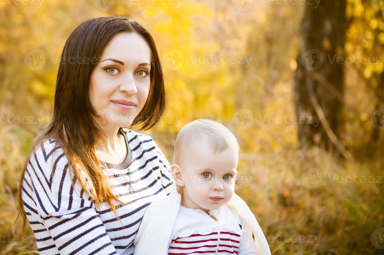 Mother with her baby daughter in autumn park photo
