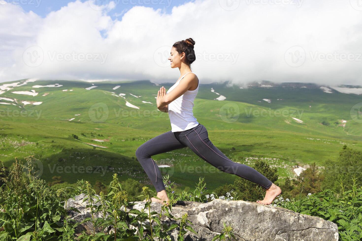 Attractive young woman doing a yoga pose for balance and stretching photo