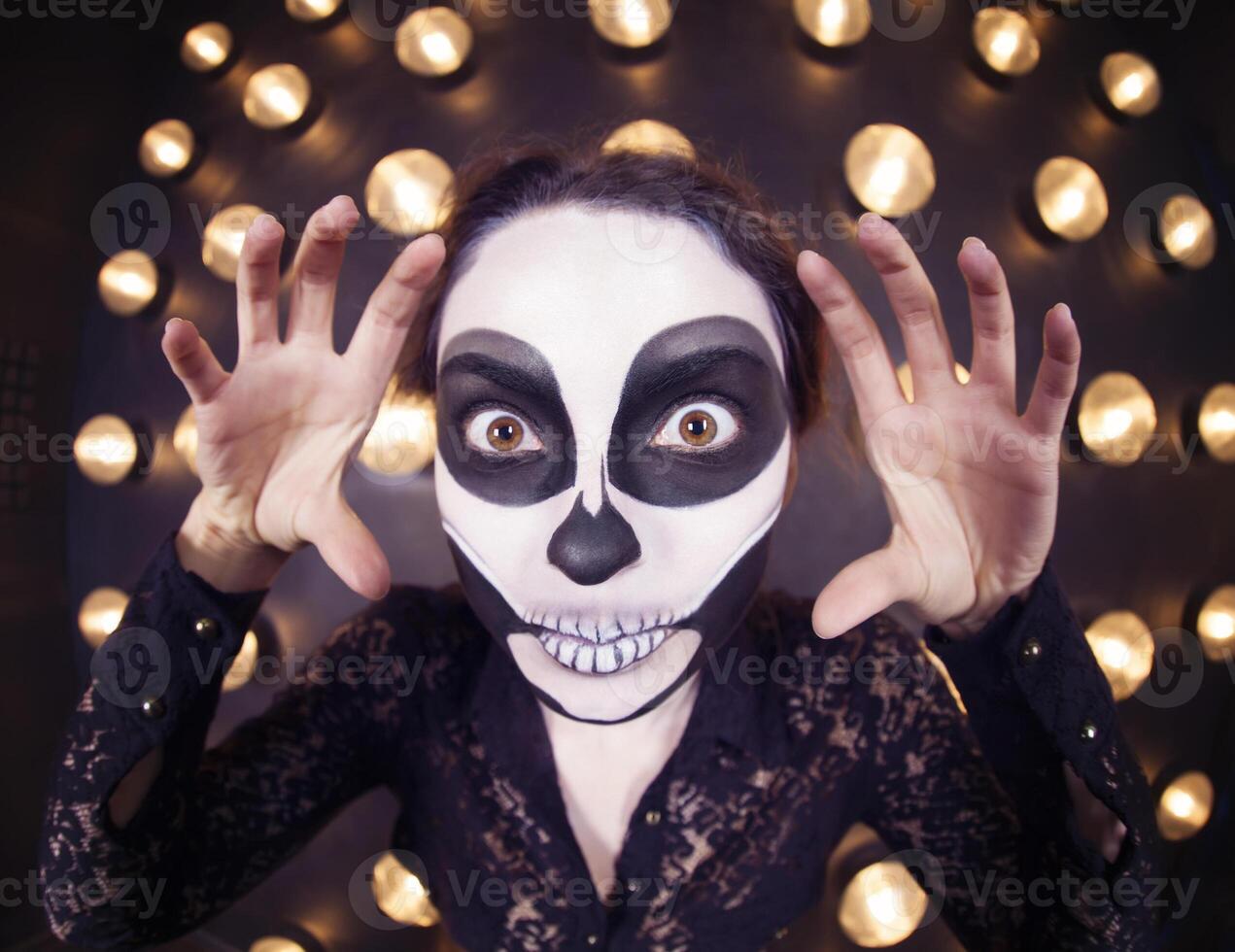 Beautiful woman painted as skeleton. Halloween theme photo