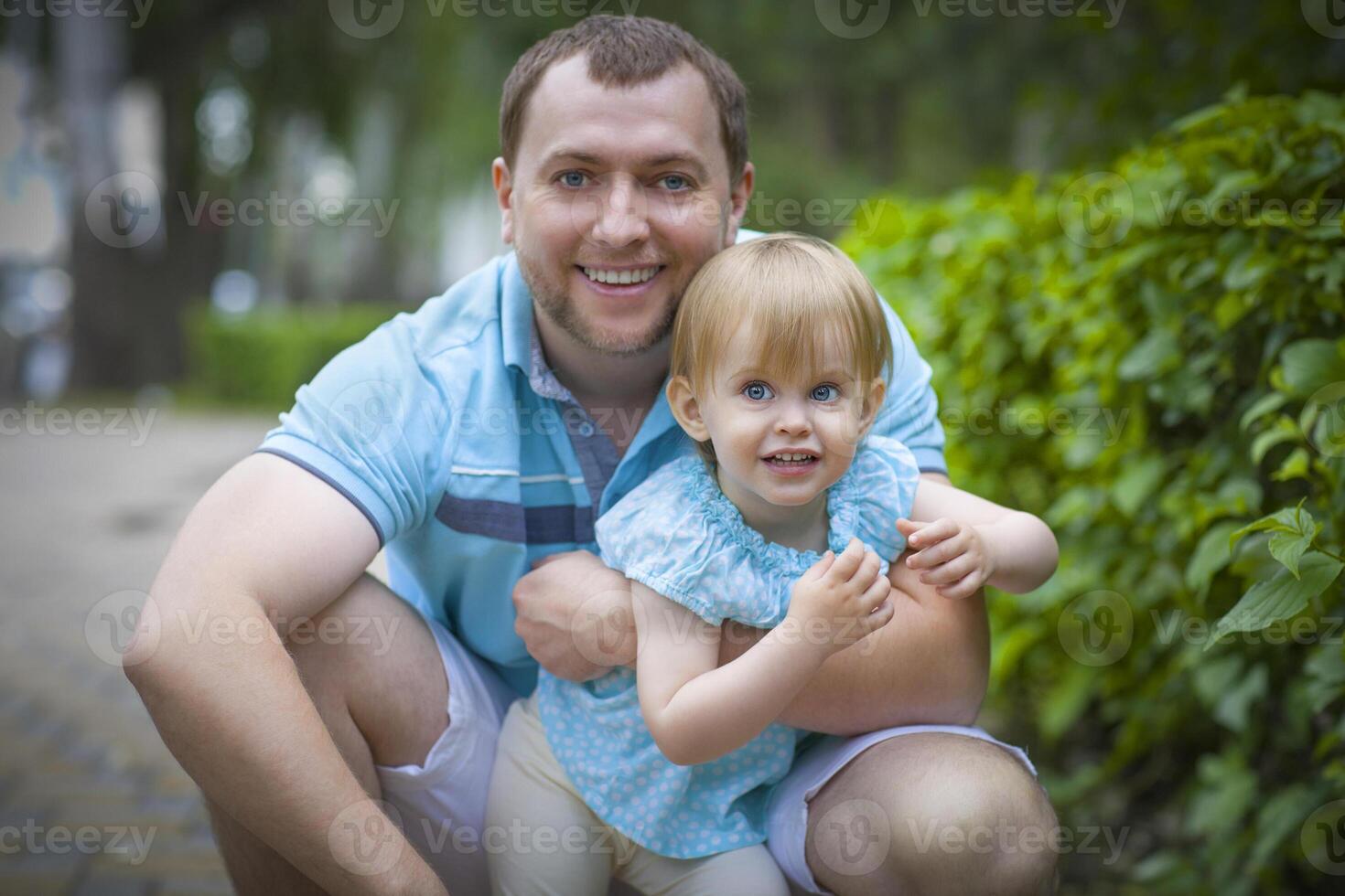 Happy young father with little daughter outdoors photo